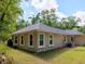 Rear of the home showing many windows to view the backyard at 7695 Sw 188Th Ave, Dunnellon, FL 34432