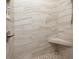 Shower with tiled walls, pebble floor, and corner seat at 7695 Sw 188Th Ave, Dunnellon, FL 34432