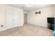 A bright bedroom featuring plush carpeting, double closets, and neutral walls at 8 Diamond Club Rd, Ocala, FL 34472