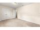 A bright bedroom featuring plush carpeting, double closets, and neutral walls at 8 Diamond Club Rd, Ocala, FL 34472