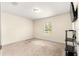 Neutral bedroom with carpet, single window for natural light, and black shelving unit at 8 Diamond Club Rd, Ocala, FL 34472