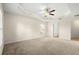 Spacious main bedroom with tray ceiling, fan, and carpet flooring at 8 Diamond Club Rd, Ocala, FL 34472