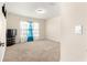 Neutral bedroom with a large window and carpeted flooring at 8 Diamond Club Rd, Ocala, FL 34472