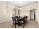 Neutral dining room with a modern chandelier over the dark wood table and carpeted floor at 8 Diamond Club Rd, Ocala, FL 34472