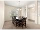Elegant dining room area with carpet, stylish chandelier, and large window at 8 Diamond Club Rd, Ocala, FL 34472