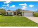 Beautiful lawn with decorative trees and shrubs leading to the home's entrance at 8 Diamond Club Rd, Ocala, FL 34472