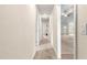 Hallway with carpet and open view to a room with a ceiling fan at 8 Diamond Club Rd, Ocala, FL 34472
