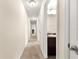 Hallway with carpet and open door to bathroom with vanity and sink at 8 Diamond Club Rd, Ocala, FL 34472
