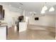 Open concept kitchen with tiled floors, an adjacent living room, and neutral-colored walls at 8 Diamond Club Rd, Ocala, FL 34472
