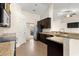 Kitchen showcasing dark wood cabinets, stainless steel appliances, and tiled floors at 8 Diamond Club Rd, Ocala, FL 34472