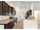 Kitchen featuring granite countertops, stainless steel appliances, and dark wood cabinets at 8 Diamond Club Rd, Ocala, FL 34472