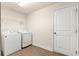 Functional laundry room with washer, dryer, and tile flooring at 8 Diamond Club Rd, Ocala, FL 34472
