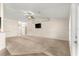 Bright living room with neutral walls, ceiling fan, mounted television, and a tiled transition at 8 Diamond Club Rd, Ocala, FL 34472