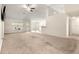 Spacious living room featuring a ceiling fan, neutral walls, and large windows for natural light at 8 Diamond Club Rd, Ocala, FL 34472