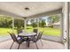 Screened-in patio furnished with a table and chairs, providing a cozy outdoor retreat at 8 Diamond Club Rd, Ocala, FL 34472