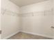 Walk-in closet with hanging racks and carpet flooring at 8 Diamond Club Rd, Ocala, FL 34472