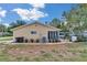 Home exterior featuring a screened patio, gravel landscaping, and gated yard at 8144 Sw 108Th Street Rd, Ocala, FL 34481