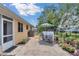A cozy back patio features an outdoor dining set, lush landscaping, and a peaceful backyard setting at 8144 Sw 108Th Street Rd, Ocala, FL 34481