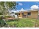 A fenced backyard with green grass, a garden, and outdoor storage sheds provides a serene outdoor space at 8144 Sw 108Th Street Rd, Ocala, FL 34481