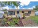 Well-maintained backyard featuring lush greenery, decorative landscaping, and a peaceful outdoor space at 8144 Sw 108Th Street Rd, Ocala, FL 34481