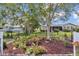 Landscaped backyard with well-maintained garden beds, creating a serene outdoor space with lush trees at 8144 Sw 108Th Street Rd, Ocala, FL 34481