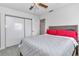 Bright bedroom features a neutral color scheme, ceiling fan, and closet with sliding doors at 8144 Sw 108Th Street Rd, Ocala, FL 34481