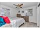 Cozy bedroom with two windows, ceiling fan, neutral colored walls and carpet at 8144 Sw 108Th Street Rd, Ocala, FL 34481