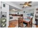 Open dining area featuring a ceiling fan, large window, with direct access to the kitchen at 8144 Sw 108Th Street Rd, Ocala, FL 34481
