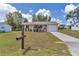 Single-story home with a green lawn, charming porch, and well-maintained landscaping at 8144 Sw 108Th Street Rd, Ocala, FL 34481