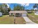 Inviting single-story home featuring a well-manicured lawn, charming porch, and attached garage at 8144 Sw 108Th Street Rd, Ocala, FL 34481