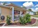 Cozy front porch with seating, charming flower baskets, and white trim at 8144 Sw 108Th Street Rd, Ocala, FL 34481