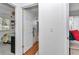 Bright hallway featuring wood-look floors and views into the bedroom and bathroom, creating an inviting transition at 8144 Sw 108Th Street Rd, Ocala, FL 34481