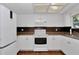 Well-lit kitchen with white appliances and cabinets, offering a clean and modern aesthetic at 8144 Sw 108Th Street Rd, Ocala, FL 34481