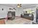Comfortable living room features a sofa, recliner, and large window with natural light, a perfect place to unwind at 8144 Sw 108Th Street Rd, Ocala, FL 34481