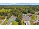 Aerial view showcasing the community pool, tennis courts, clubhouse, and mature trees at 8247 Sw 105Th Pl, Ocala, FL 34481