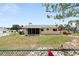 Backyard view showcasing a fenced in yard and screened in lanai of this charming home at 8247 Sw 105Th Pl, Ocala, FL 34481