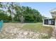 A view of the backyard showing the chain link fence and screened-in porch at 8247 Sw 105Th Pl, Ocala, FL 34481