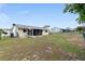 Spacious fenced backyard with a well-maintained lawn and a screened in porch at 8247 Sw 105Th Pl, Ocala, FL 34481