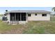 Backyard view of the screened-in porch and surrounding yard space, with chain link fence at 8247 Sw 105Th Pl, Ocala, FL 34481