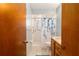 Well-lit bathroom with tiled shower and vanity at 8247 Sw 105Th Pl, Ocala, FL 34481