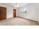 This bedroom features neutral walls, carpet, a window view, and a closet at 8247 Sw 105Th Pl, Ocala, FL 34481
