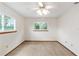 Bedroom with neutral walls, neutral carpet, two windows, and a ceiling fan with light at 8247 Sw 105Th Pl, Ocala, FL 34481