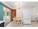 Charming kitchen nook with backyard access and adjacent refrigerator at 8247 Sw 105Th Pl, Ocala, FL 34481