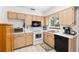 Functional kitchen with white appliances, wood cabinets, and ample counter space at 8247 Sw 105Th Pl, Ocala, FL 34481