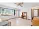 Bright living room with tile floors, ceiling fan, and a view from the large window at 8247 Sw 105Th Pl, Ocala, FL 34481