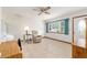 Comfortable living area features tile floors, a ceiling fan, and ample natural light, creating a welcoming space at 8247 Sw 105Th Pl, Ocala, FL 34481