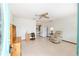 Open floor plan living room with tile flooring, ceiling fan, and neutral decor offers a bright and airy feel at 8247 Sw 105Th Pl, Ocala, FL 34481