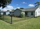 Large, fenced backyard with lush grass, great for outdoor activities at 8320 Sw 108Th Place Rd, Ocala, FL 34481