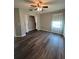 Bright bedroom featuring wood-look flooring, a ceiling fan, and natural light at 8320 Sw 108Th Place Rd, Ocala, FL 34481