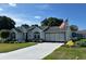 Charming home exterior with meticulous landscaping, driveway and attached garage at 8320 Sw 108Th Place Rd, Ocala, FL 34481
